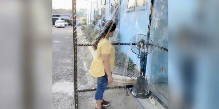 Seorang pengunjung tampak memasuki sterilizer room sebelum diperkenankan memasuki kompleks gedung PDAM Tirtauli, Senin (30/3/2020).