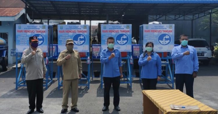 Pj Sekda Kusdianto dan Ketua Gugus Tugas Covid-19 Midian Sirait foto bersama dengan jajaran direksi PDAM Tirtauli usai penyerahan bantuan untuk pencegahan wabah Covid-19, di halaman PDAM Tirtauli, Senin pagi (20/4/2020).