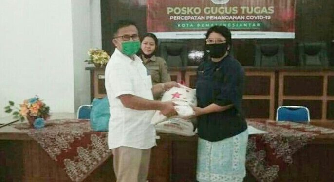 Kabag Keuangan PDAM Tirtauli, Muliadi SE, saat menyerahkan bantuan sembako dari PDAM Tirtauli yang diterima oleh petugas Gugus Tugas Covid-19 Pemko Pematangsiantar, Jumat (8/5).