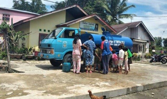Masyarakat Jl Manunggal Karya tampak antri mengambil air dari mobil tangki gratis PDAM Tirtauli, Kamis (28/5) pagi.