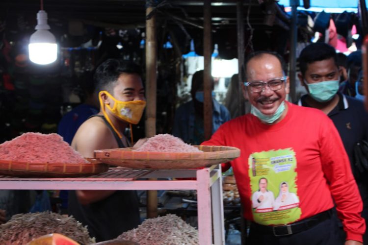 Asner Sialahi mengenakan kaos lengan panjang warna merah saat mengunjungi pedagang Pasar Horas pada November 2020 lalu.