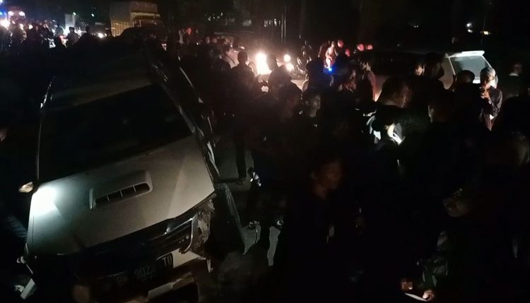 Warga mengerumuni mobil yang terperosok ke dalam parit yang sebelumnya diduga telah melakukan tabrak lari, Sabtu (28/9) malam.